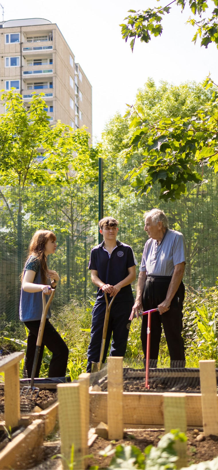 Senior pupils with a teacher in the garden learning about the gardening techniques at Ibtsock Place School